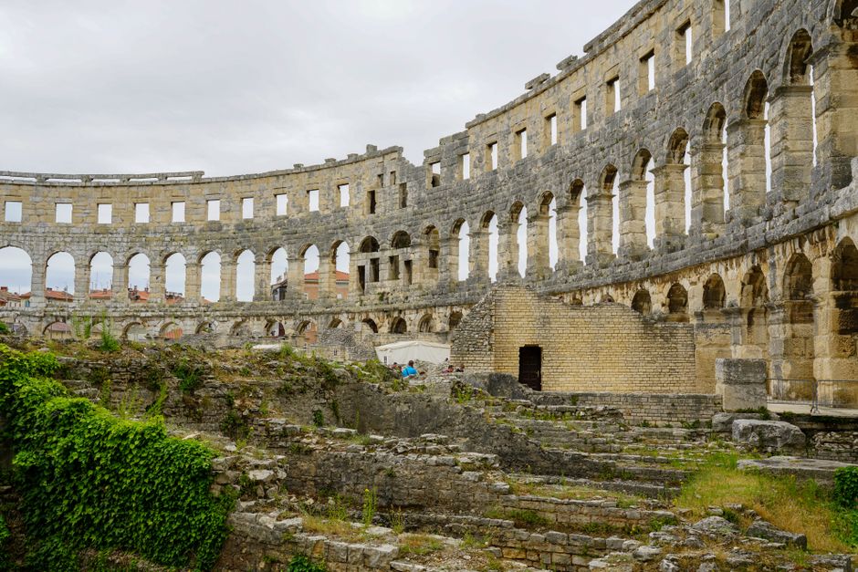 Explore the historic Roman amphitheater ruins in Pula, a major tourist attraction in Croatia.
