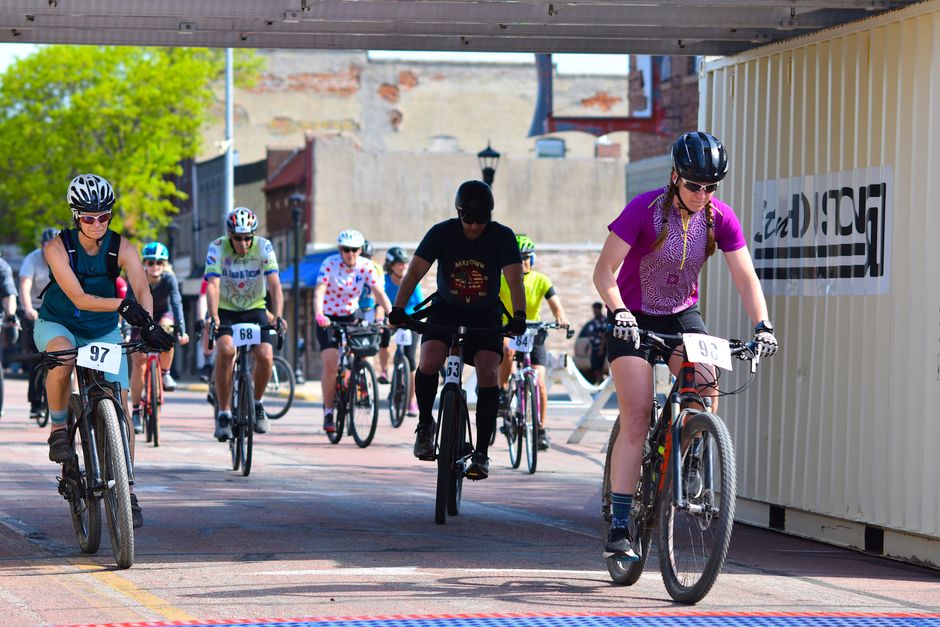 A dynamic shot of cyclists competing in an urban street bike race, showcasing diverse participants.