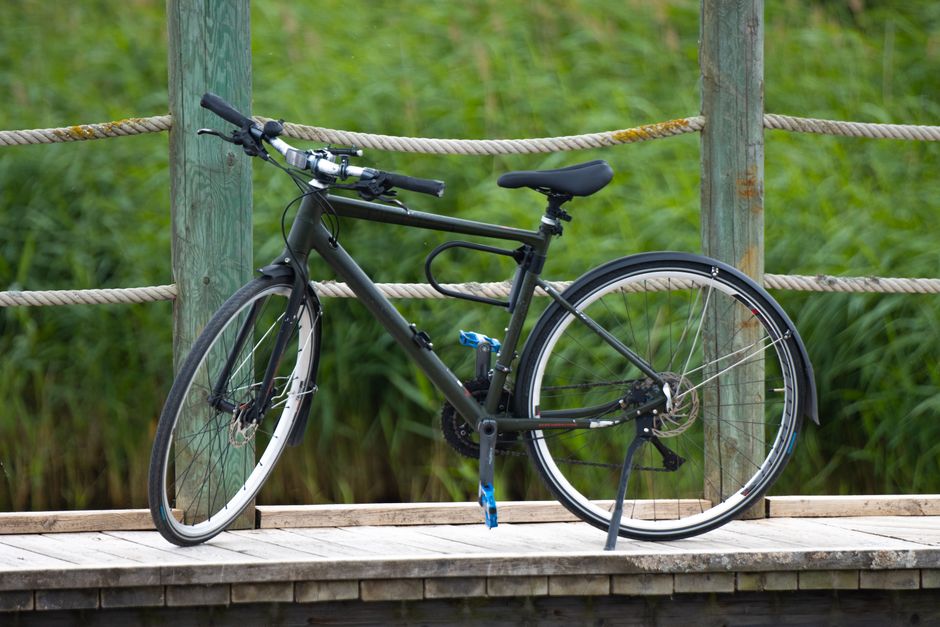 A bicycle resting on a wooden bridge surrounded by greenery in Jönköping, Sweden.
