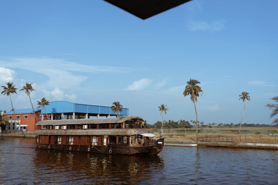 A traditional houseboat cruising through the serene backwaters of Alappuzha, Kerala, India.