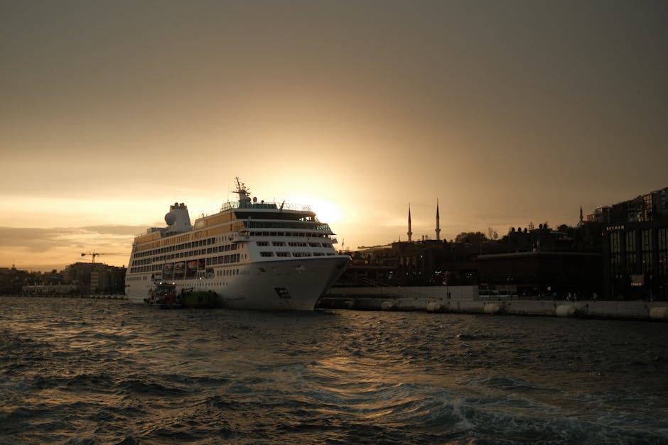 A majestic cruise ship docked at sunset in Istanbul with iconic skyline views.