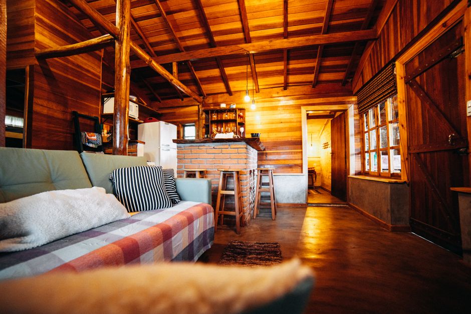 A charming rustic interior with wooden beams and warm lighting, perfect for cozy retreats.