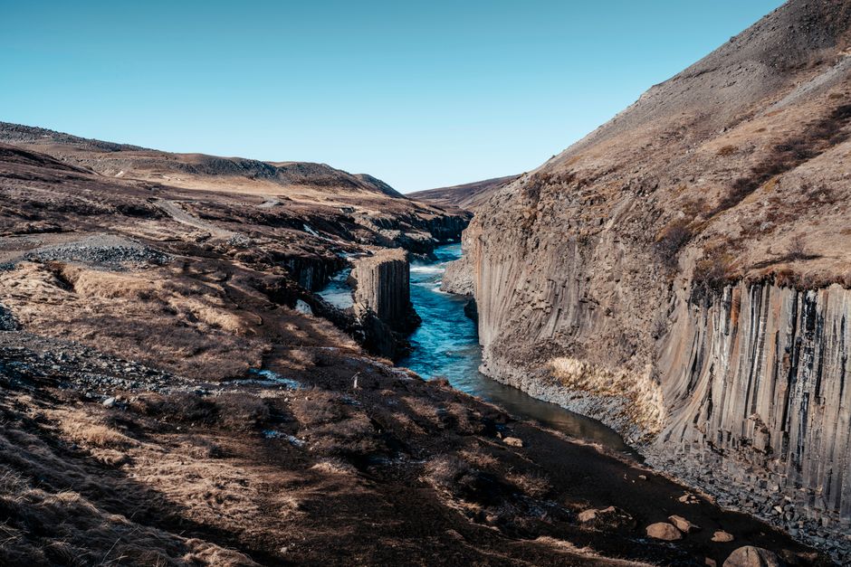 Breathtaking view of a canyon with basalt cliffs and a river in Iceland.