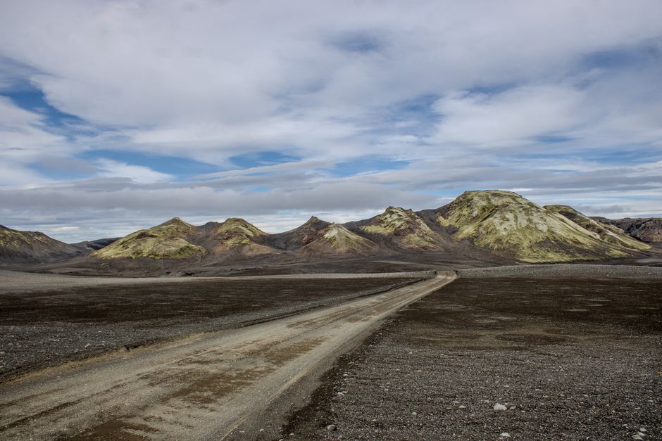 Expansive view of Skaftárhreppur's volcanic terrain under a cloudy sky.