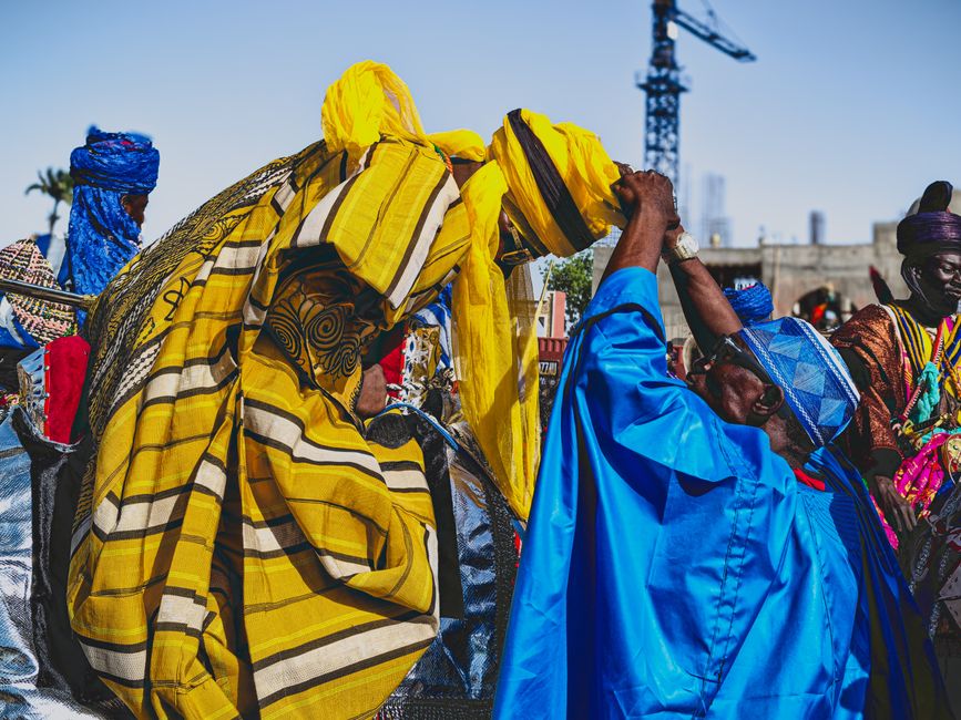 Vibrant street celebration with people in colorful traditional attire, capturing cultural diversity.