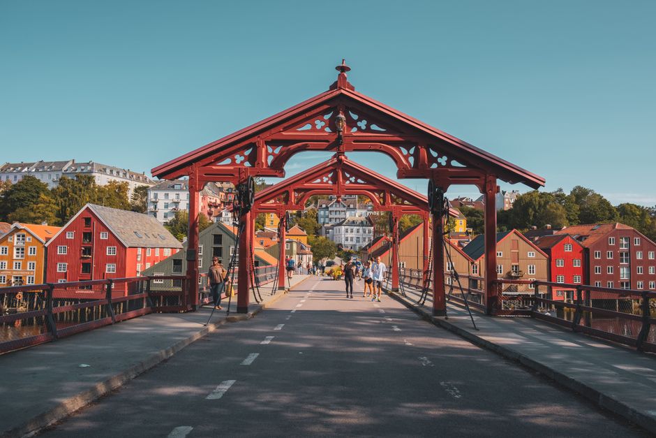 Charming view of the Old Town Bridge in Trondheim, Norway, with colorful wooden houses.