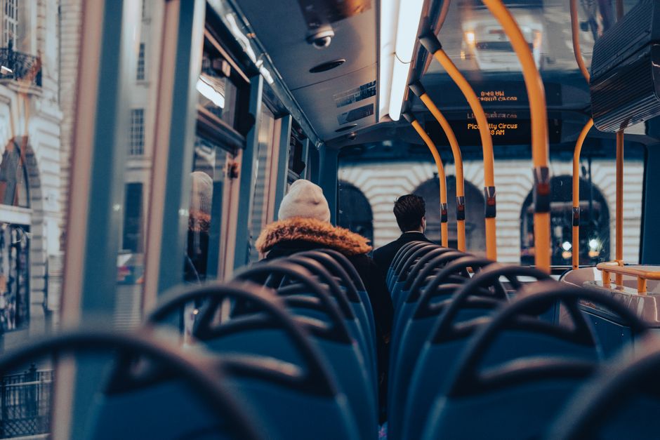 Passengers traveling on a city bus through London, capturing urban commuting life.