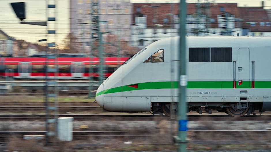 Dynamic image of high-speed trains travelling at an urban station, showcasing motion and modern transportation.