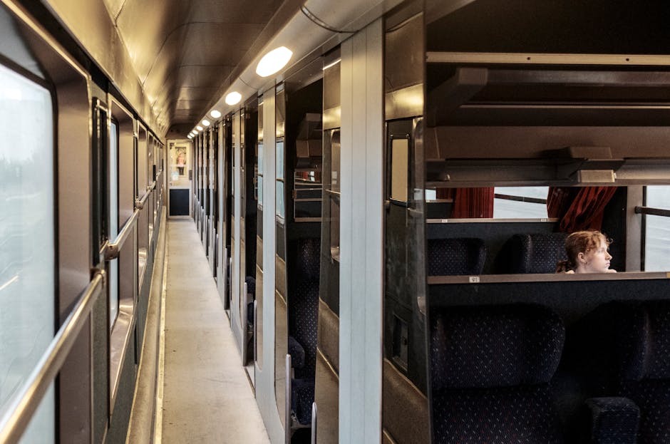 A young girl sitting alone in a train cabin, traveling through France. Peaceful and serene ambiance.